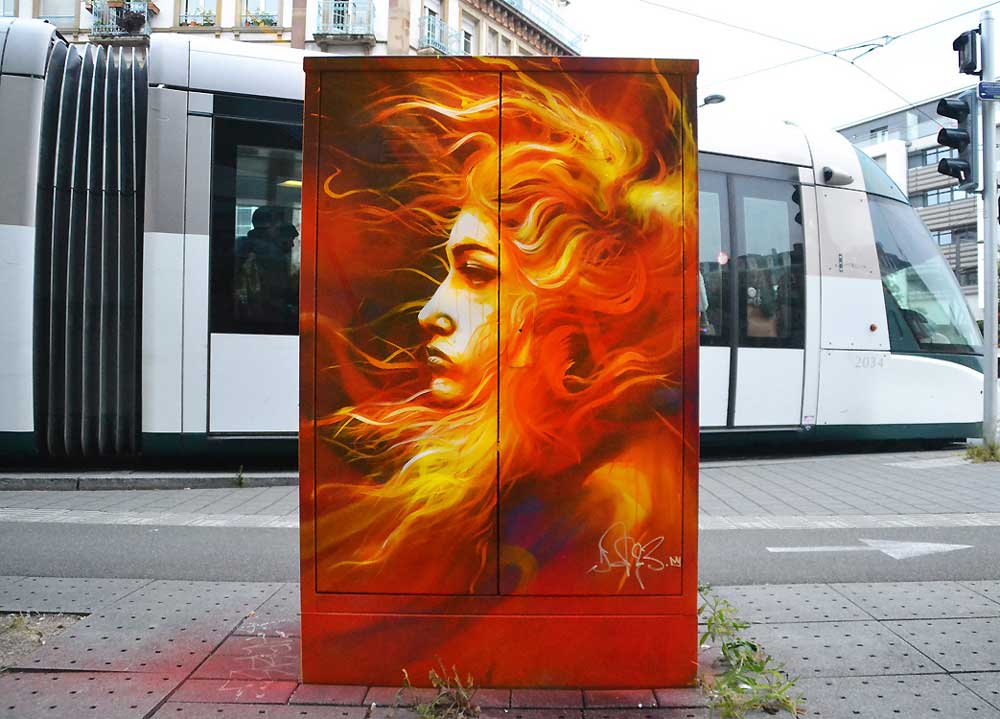 A woman in fire on an electrical cabinet